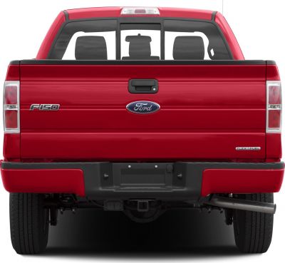 Red pickup truck rear view with tailgate, taillights, and exhaust pipe