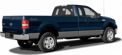 Side-rear view of pickup truck with extended cab and 4x4 badge