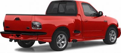 Red pickup with dual exhausts, alloy wheels, rear and side view