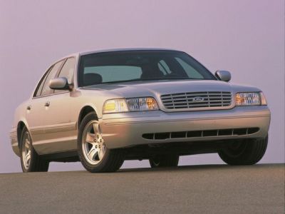 Front and side view of a classic sedan with prominent grille and headlights.