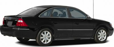 Side profile of a black sedan with four doors and alloy wheels