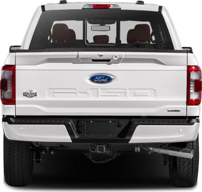 Rear view of pickup tailgate and bumper with dual wheels.