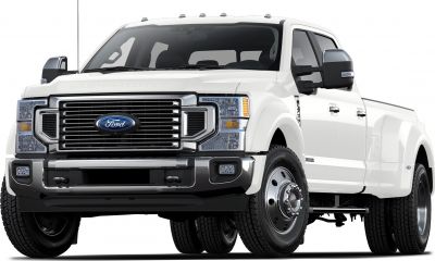 Heavy duty pickup truck front with grille and dual rear wheels.