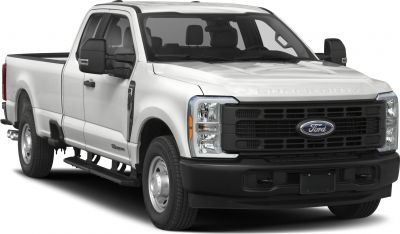Front-side of pickup with robust grille, dual side mirrors, and step bars.