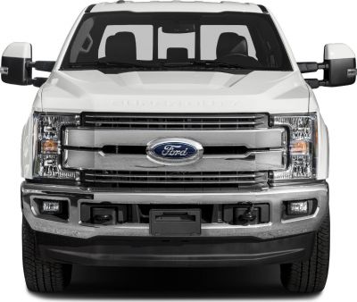 Front grille, headlights, side mirrors, and chrome bumper of a pickup truck