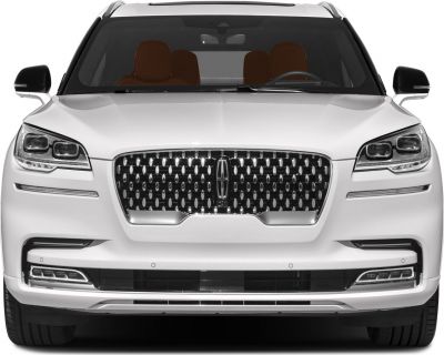Prominent grille and dual LED headlights on a luxury SUV front.