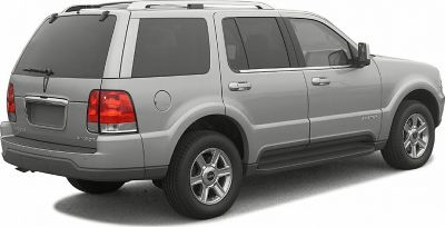 Silver SUV rear side view with roof rails and tinted windows