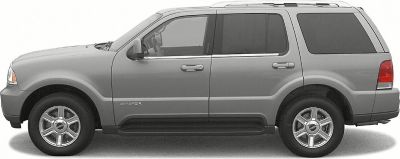 Side profile of a classic luxury SUV with four doors and alloy wheels.