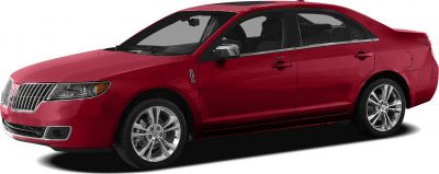 Red sedan with chrome grille and alloy wheels in side profile