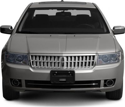 Luxury sedan front with vertical grille bars, clear headlights, fog lights
