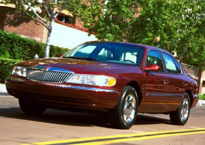 Front three-quarter view of luxury sedan with chrome grille and smooth body