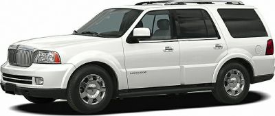 White full-size SUV with chrome grille and roof rails side view.
