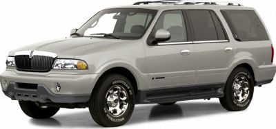 Front side view of a silver SUV with rugged body and classic design