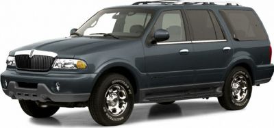 Front three-quarter view of a rugged large SUV with roof rails and chrome wheels
