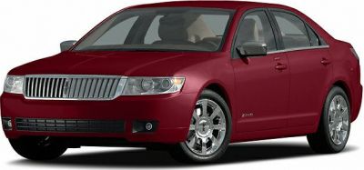Front angle of luxury four-door sedan with chrome wheels and distinct grille.