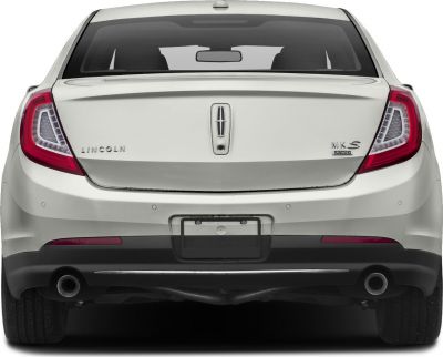 Rear view with tail lights, dual exhaust, trunk, and license plate area