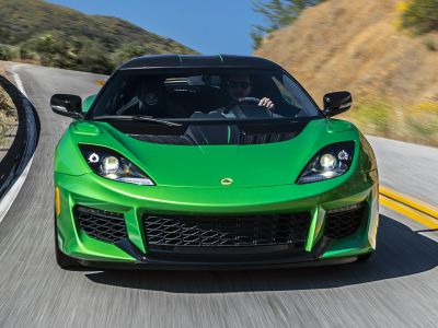 Green sports car front with aggressive air intakes and headlights