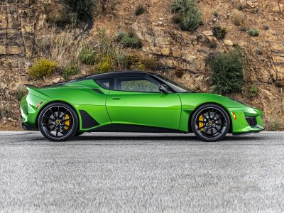 Green sports car side profile with black wheels and yellow brake calipers