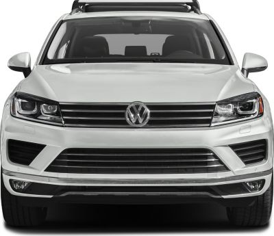 Front view with LED headlights, horizontal grille, and roof racks