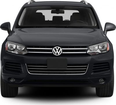 Front SUV view with dual headlights, chrome grille, roof rails, and fog lights