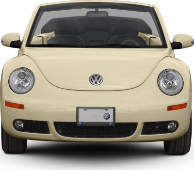 Front view, round headlights, VW logo, beige convertible