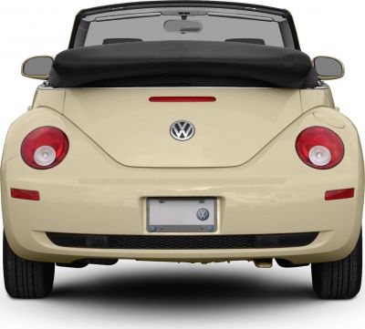 Rear view of convertible with rounded tail lights and folded soft top.