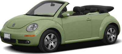 Compact convertible with folded soft top and round headlamps