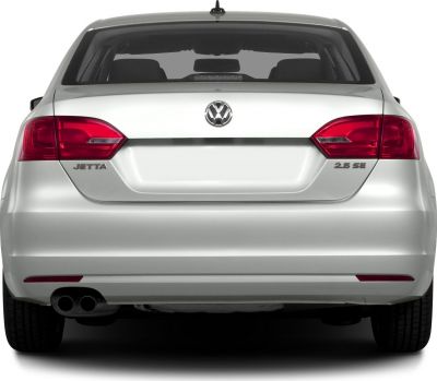 Rear view with taillights, dual exhaust, trunk, and emblem
