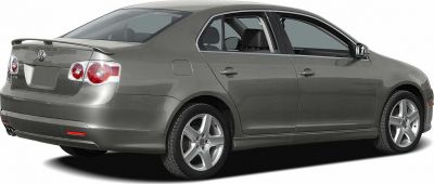 Rear and side view of a sleek sedan with distinctive taillights and alloy wheels