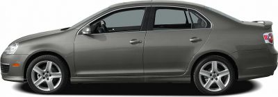 Side profile of sedan with alloy wheels and rear spoiler