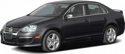 Front side view of a sedan with alloy wheels and chrome-trimmed grille