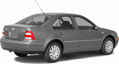 Rear side view of a grey four-door sedan with TDI badge