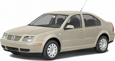 Beige sedan front side view with classic 1990s design and alloy wheels