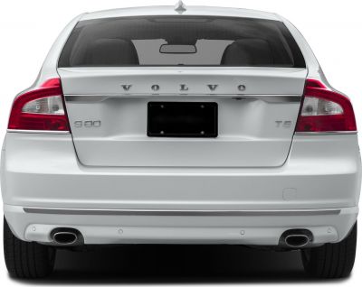 Rear view of sedan featuring taillights, dual exhausts, and trunk details
