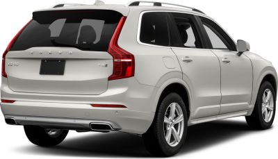 SUV rear with vertical tail lights, dual exhaust, and roof rails.