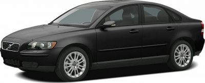 Black sedan front side view showing smooth lines and alloy wheels