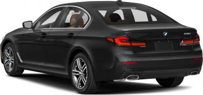 Rear side view of black luxury sedan with sharp taillights and dual exhausts