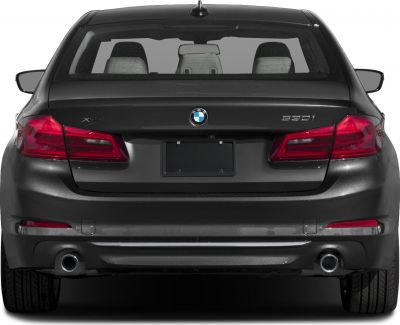 Rear view with taillights, exhaust pipes, and trunk lid of a sedan