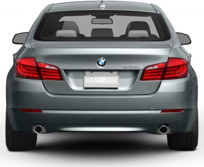 Rear view of sedan with dual exhausts and LED taillights