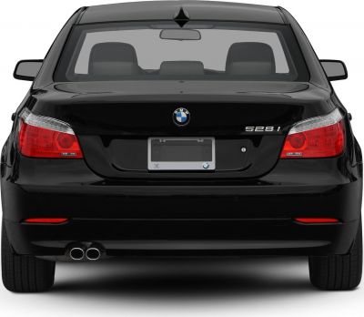 Rear view with tail lights, emblem, and dual exhaust