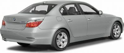 Rear and side view of a sleek sedan with distinctive taillights and alloy wheels.