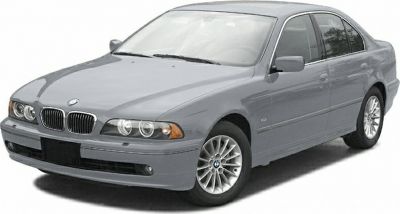Front-side view of sedan with dual round headlights and alloy wheels
