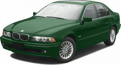 Front-side view of a green sedan with distinct headlights and alloy wheels