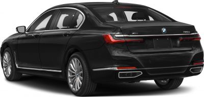 Rear side view of luxury sedan with chrome trim and dual exhausts.