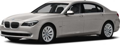Front side view of hybrid sedan with distinctive badge
