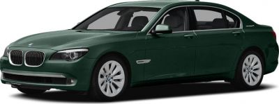 Front side view of green luxury sedan with hybrid badge