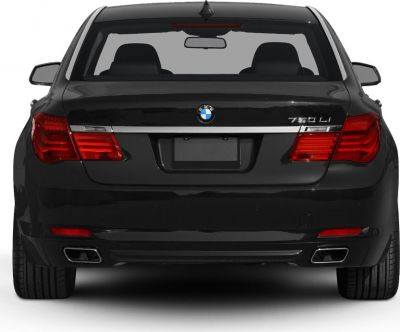 Rear view showing tail lights, BMW badge, and dual exhaust pipes
