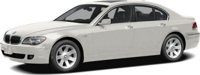 White luxury sedan front-side view with smooth body lines and alloy wheels