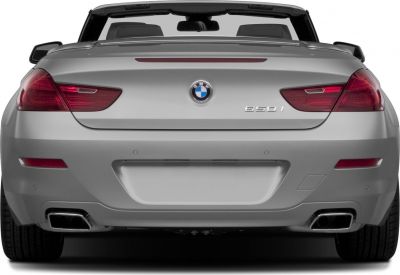Rear view of silver convertible with tail lights and dual exhausts
